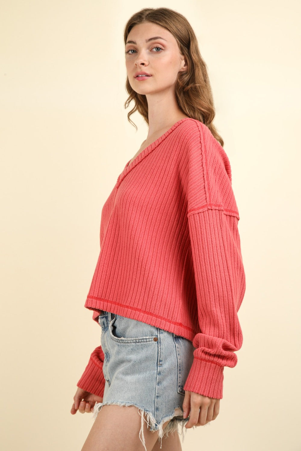 Woman wearing the Exposed Seam V-Neck Top with a stylish, modern outfit